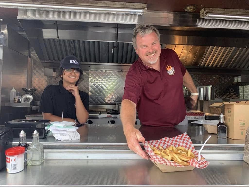 Lisa's Sunset Grill crew serving fries